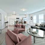 Every home at Lakewood Manor in Lake Jackson, TX, features an open-concept living and dining area with luxury vinyl plank flooring and plenty of natural light.