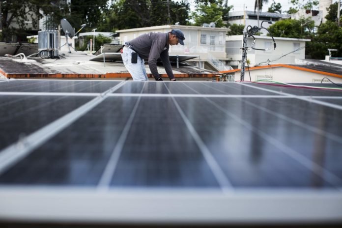 Solar panels are installed at Clínica Iella in San Juan, Puerto Rico, on July 5, 2018. The system, funded by Direct Relief, will help the clinic maintain operations in the event of a power interruption. (Photo by Erika P. Rodriguez for Direct Relief)