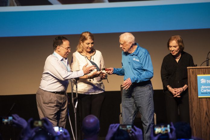 Former President Jimmy Carter and former First Lady Rosalynn Carter mark the announcement of the 2020 Carter Work Project by passing a ceremonial trowel to Cesarina Fabián and Celso Marranzini representing Habitat for Humanity Dominican Republic.