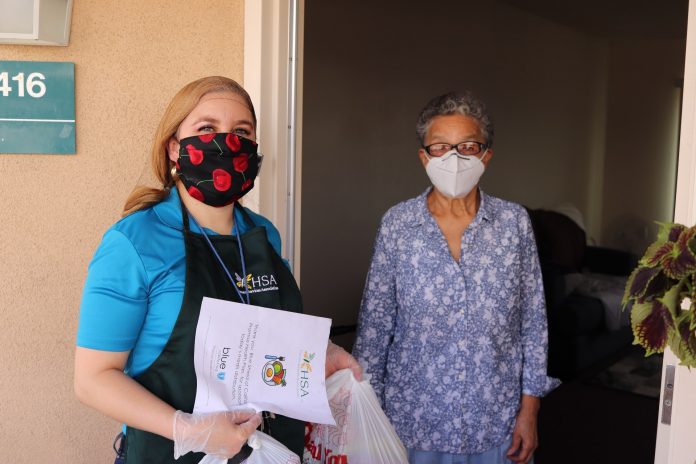 Maria Villareal from Los Angeles was surprise and thankful to received a nutritious food delivery bag by Human Services Association.