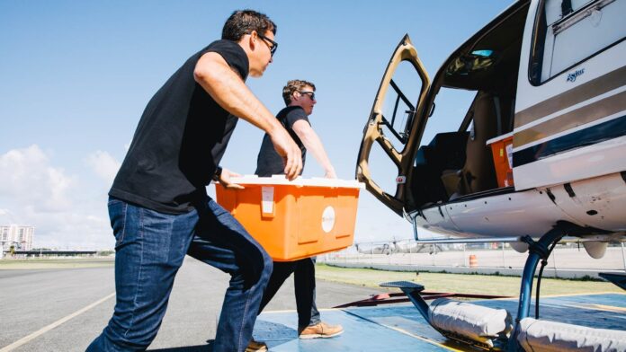 Direct Relief staff load critical medicines and supplies onto a helicopter in San Juan following Hurricane Maria in 2017. The medicines went to Health ProMed Health Center on the island of Vieques. (Photo by Donnie Hedden for Direct Relief)